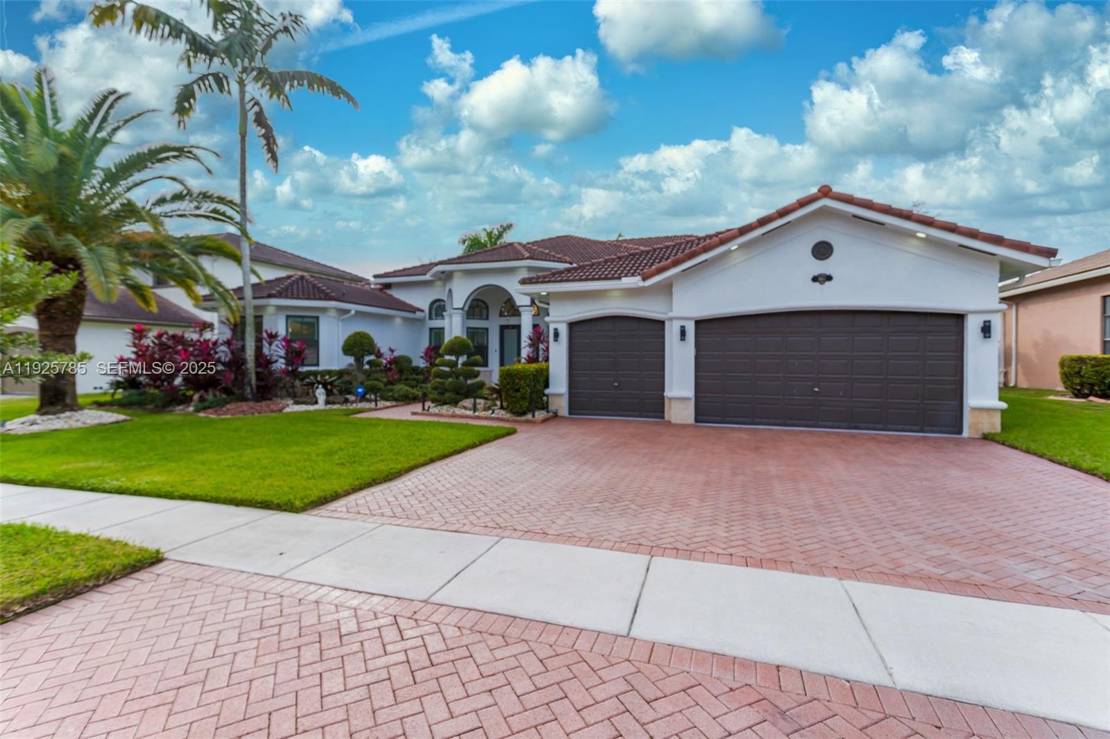 1962 Southwest 185th Avenue Miramar, FL 33029 - Photo 54 of 55 a front view of a house with a yard and garage