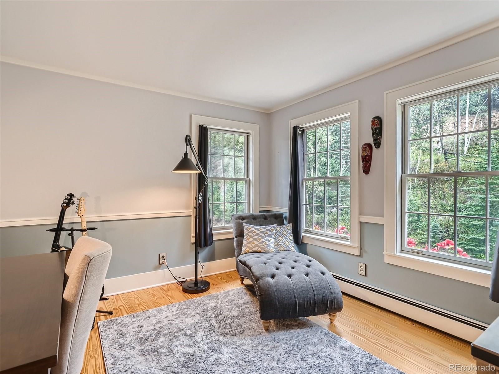 4387 Witter Gulch Road Evergreen, CO 80439 - Photo 16 of 31 a room with furniture and window