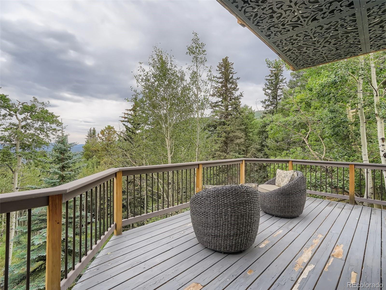 4387 Witter Gulch Road Evergreen, CO 80439 - Photo 25 of 31 a balcony with wooden floor and wooden floor