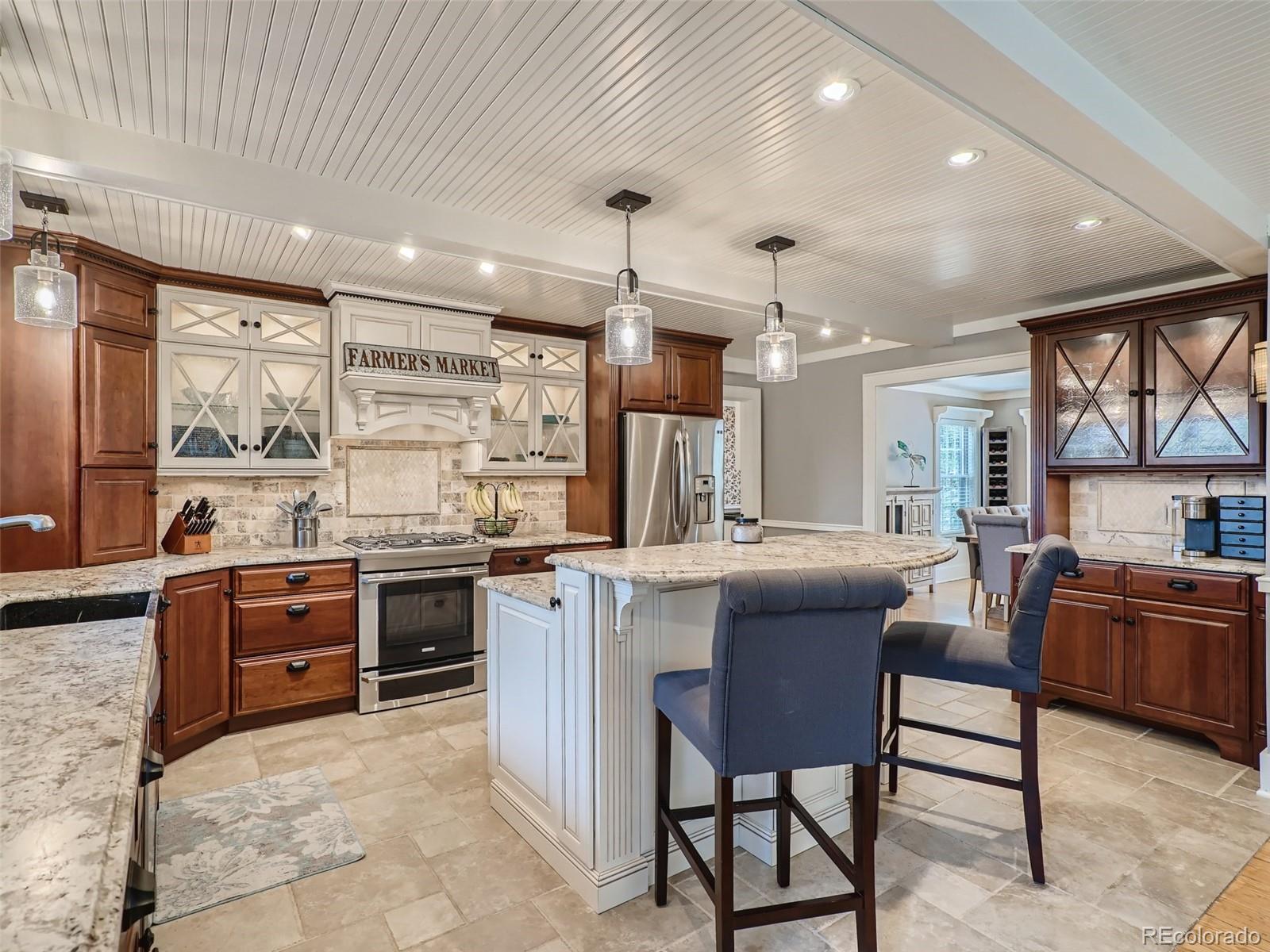 4387 Witter Gulch Road Evergreen, CO 80439 - Photo 8 of 31 a kitchen with stainless steel appliances granite countertop table chairs stove and sink