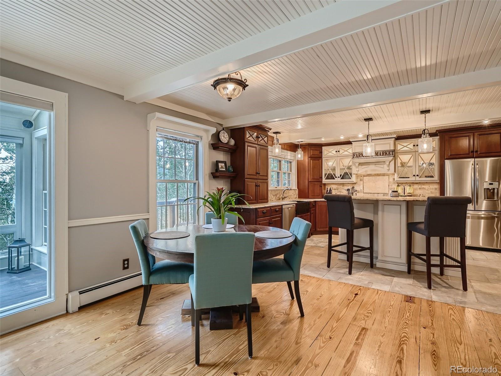 4387 Witter Gulch Road Evergreen, CO 80439 - Photo 9 of 31 a view of a dining room with furniture window and wooden floor