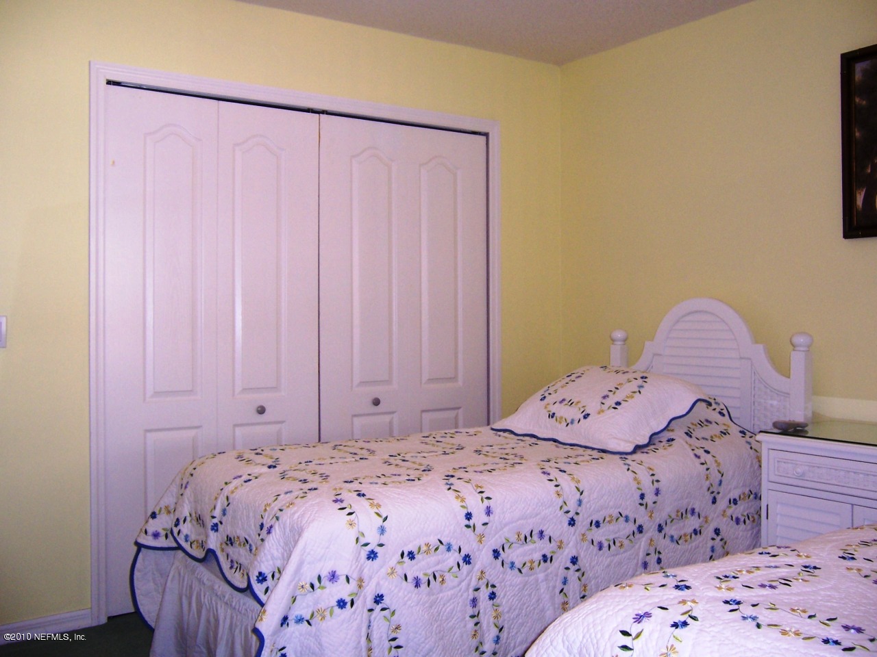 516 Moultrie Wells Road St. Augustine, FL 32086 - Photo 13 of 18 a bedroom with a bed and a chair