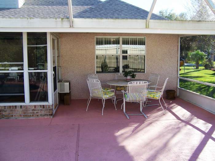 516 Moultrie Wells Road St. Augustine, FL 32086 - Photo 16 of 18 a view of a backyard with a patio and outdoor seating