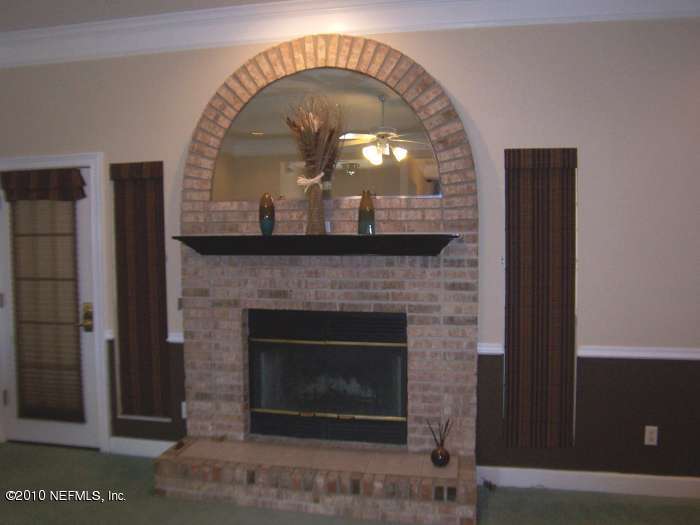 516 Moultrie Wells Road St. Augustine, FL 32086 - Photo 4 of 18 a close view of a fireplace