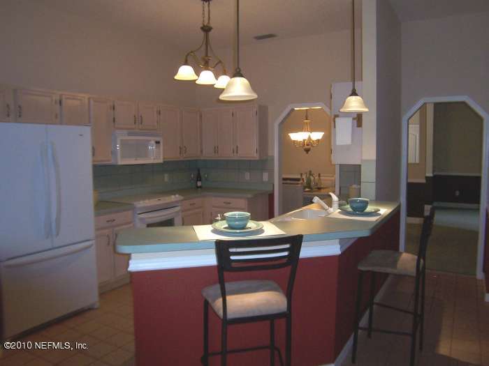 516 Moultrie Wells Road St. Augustine, FL 32086 - Photo 7 of 18 a kitchen with a sink cabinets and window