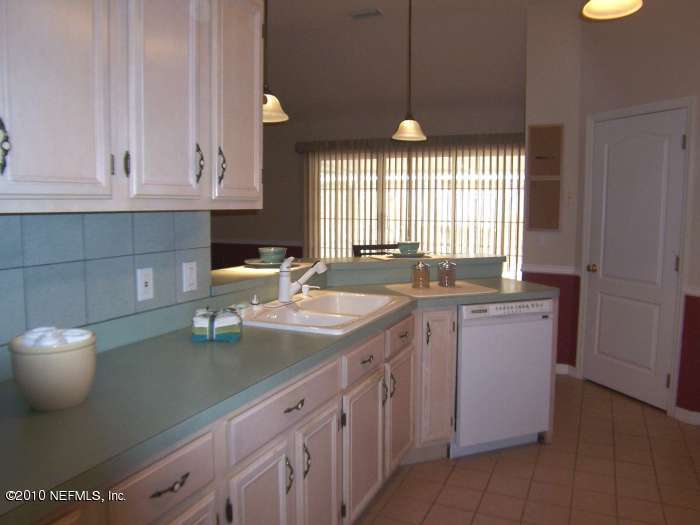 516 Moultrie Wells Road St. Augustine, FL 32086 - Photo 8 of 18 a kitchen with a sink and cabinets