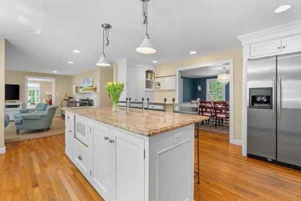 a kitchen with granite countertop a large counter top space a sink stainless steel appliances and cabinets
