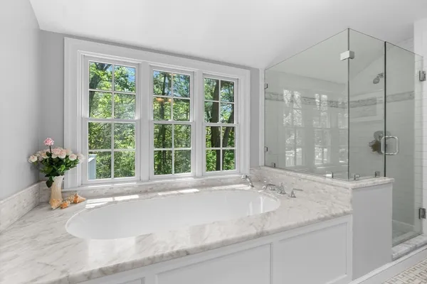 a bathroom with a granite countertop sink and a large mirror