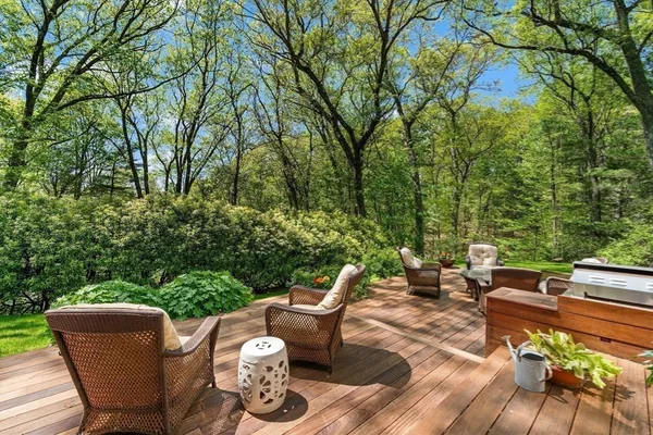 a view of a patio with lawn chairs under an umbrella