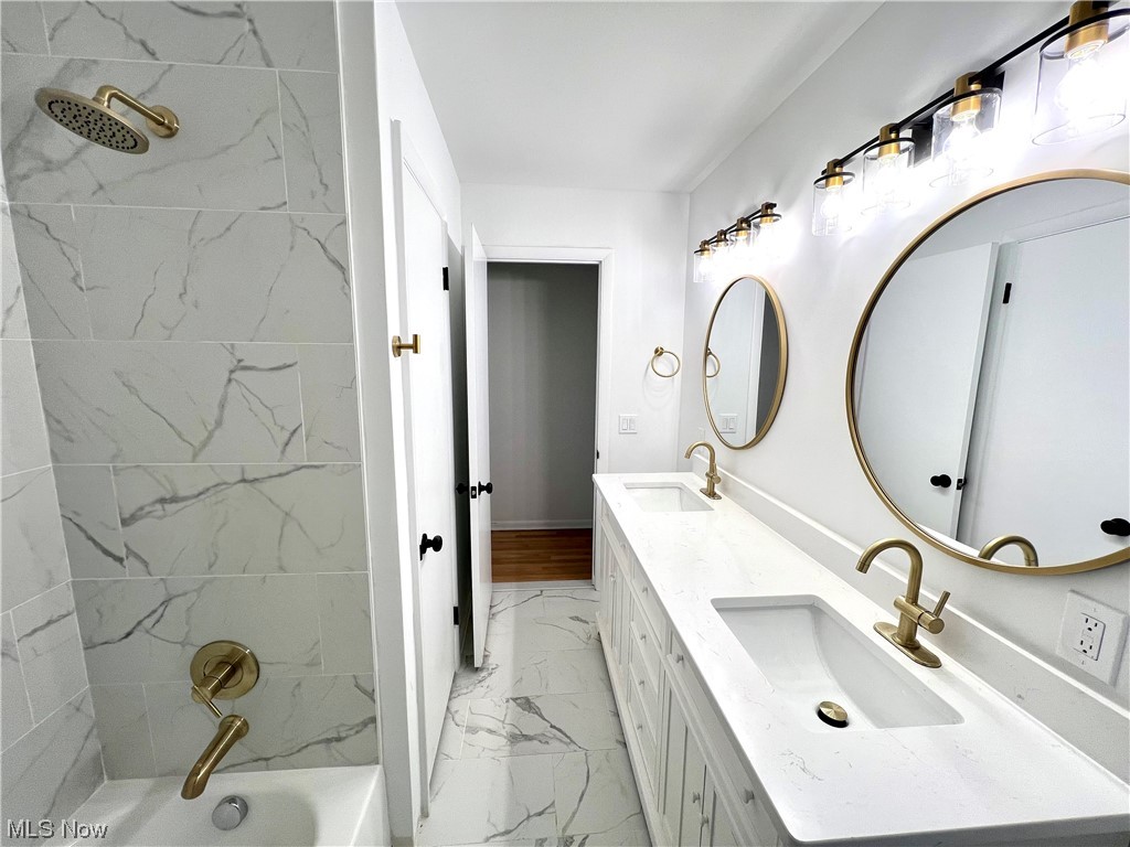 7687 Ragall Parkway Cleveland, OH 44130 - Photo 20 of 37 Bathroom with tiled shower / bath, dual vanity, and tile flooring