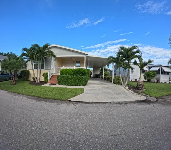 a view of a house with palm trees