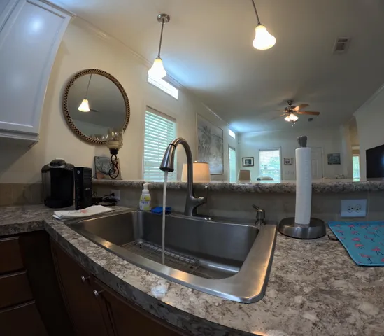 a kitchen with a sink and a granite counter top