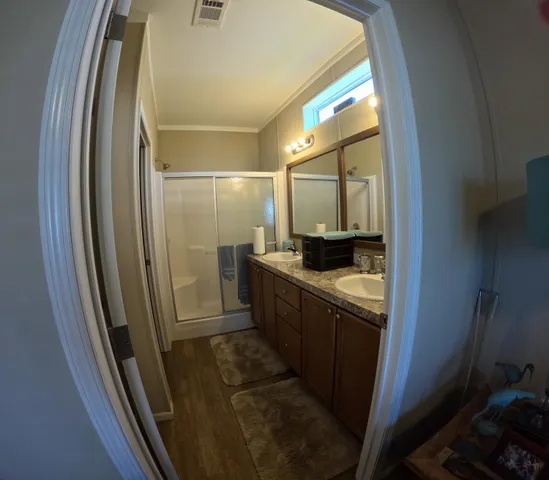 a bathroom with a double vanity sink and a mirror