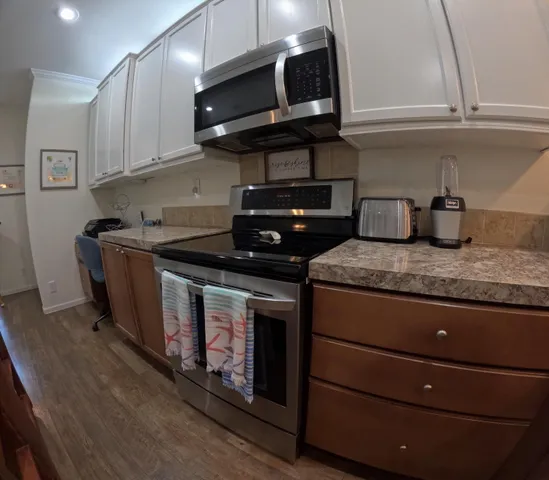 a kitchen with stainless steel appliances granite countertop a stove and a sink