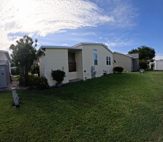 a backyard of a house with table and chairs