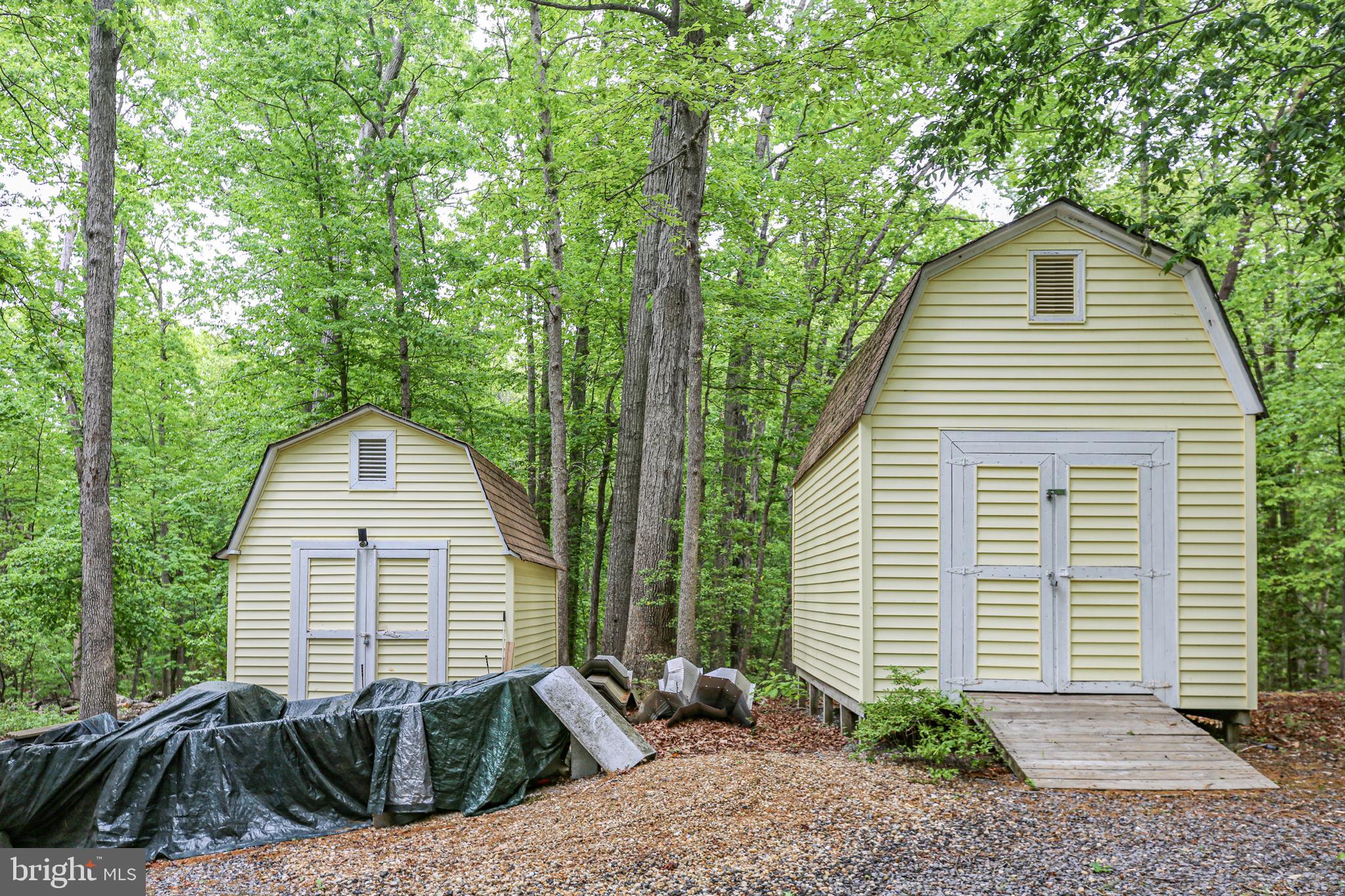 143 Cranes Corner Road Fredericksburg, VA 22405 - Photo 25 of 26 Charming sheds nestled in lush greenery.