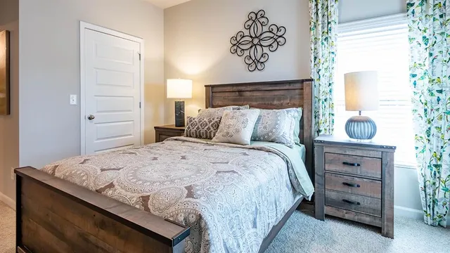 a bedroom with a bed and a window