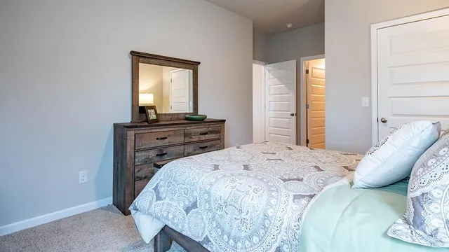 a spacious bedroom with a bed and window