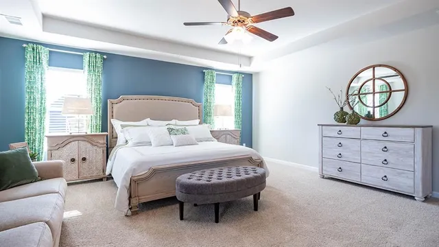 a white bath tub sitting in a bathroom next to a window