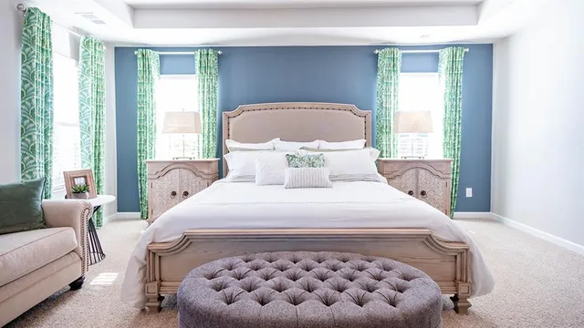 a living room with furniture a lamp and windows