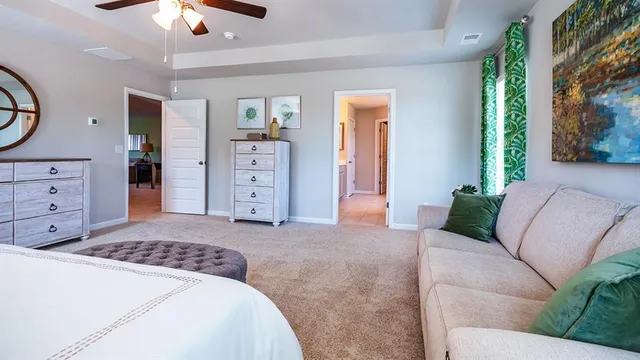 a living room with furniture a lamp and a window