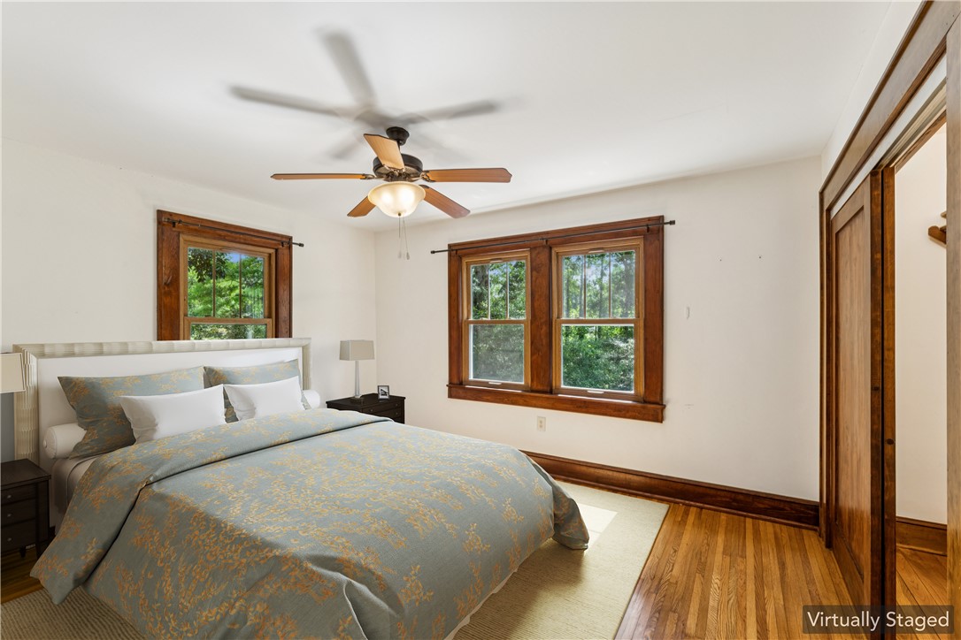 321 South Pine Street Walhalla, SC 29691 - Photo 12 of 32 Well-lit sleeping quarters with rich hardwood flooring and a functional ceiling fan for comfort.