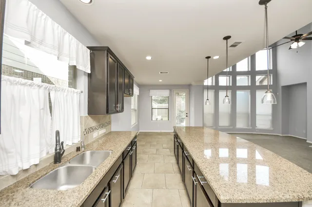 a large white kitchen with a large window