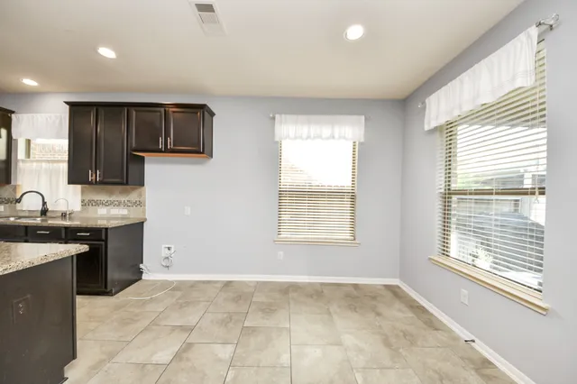 a view of a kitchen with sink cabinets and outdoor space