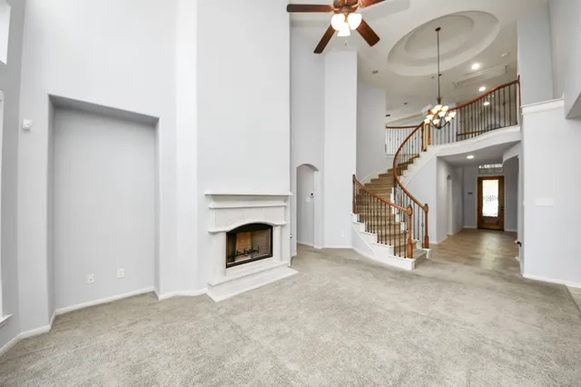 a view of entryway and hall with a fireplace