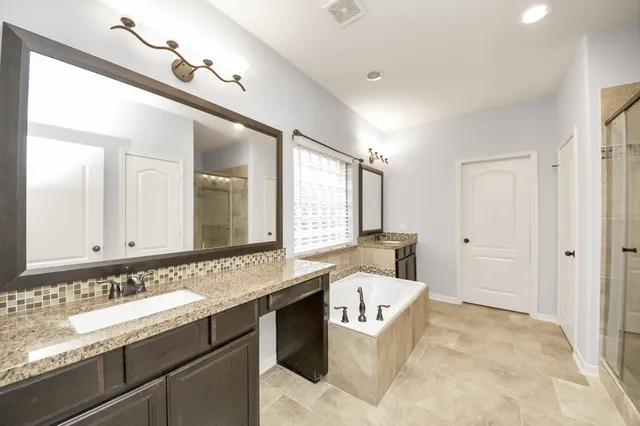 a bathroom with a granite countertop sink mirror and a