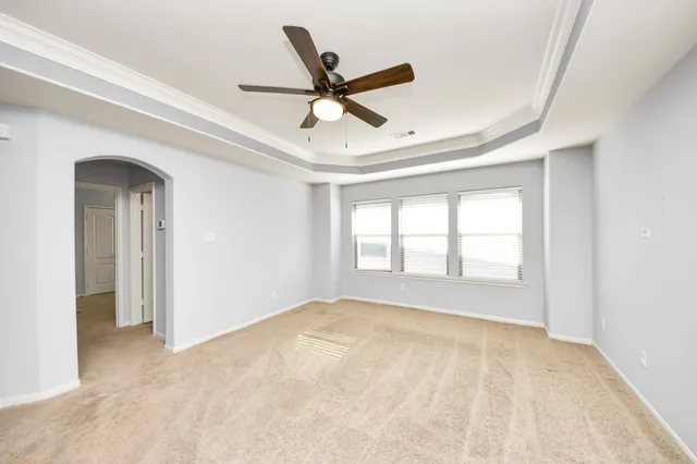 a view of a livingroom with a ceiling fan and window