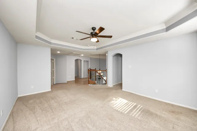 a view of workspace with wooden floor and ceiling fan