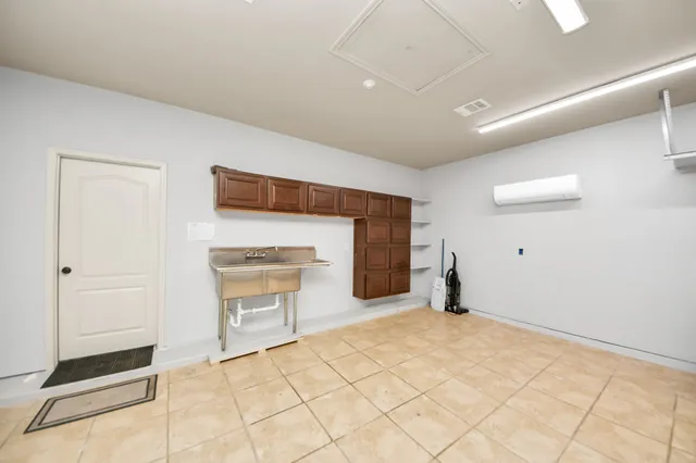 a view of an empty room with a fireplace and a cabinet