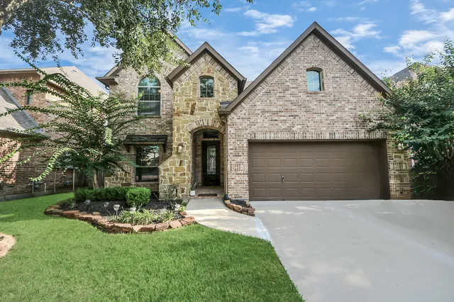 a front view of a house with a yard and garage