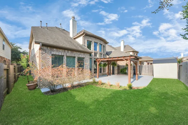 a front view of house with a garden and balcony