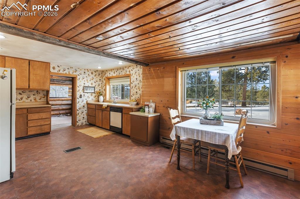 2300 Rampart Range Road Woodland Park, CO 80863 - Photo 17 of 45 a dining hall with stainless steel appliances granite countertop a stove kitchen island a table and chairs in it