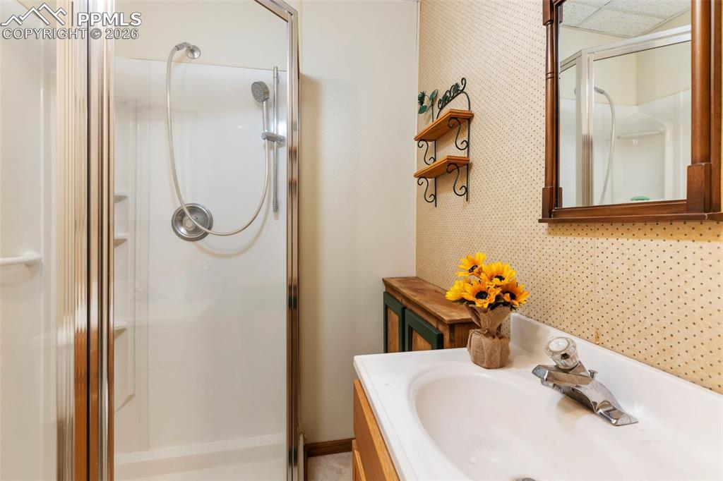 2300 Rampart Range Road Woodland Park, CO 80863 - Photo 18 of 45 a bathroom with a sink and mirror