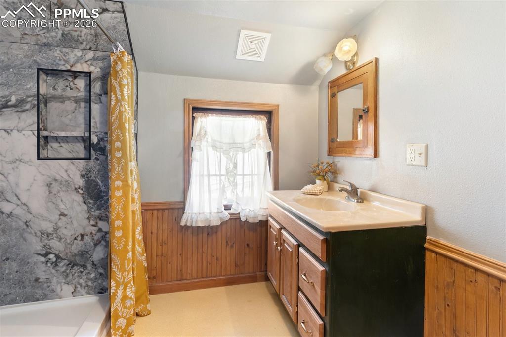 2300 Rampart Range Road Woodland Park, CO 80863 - Photo 30 of 45 a bathroom with a sink a vanity and a mirror