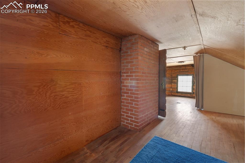 2300 Rampart Range Road Woodland Park, CO 80863 - Photo 32 of 45 a view of an empty room with wooden floor and a window