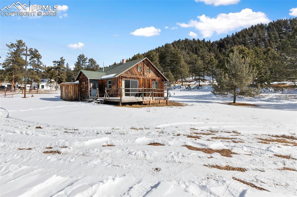 2300 Rampart Range Road Woodland Park, CO 80863 - Photo 33 of 45 a view of a house with a yard covered in snow