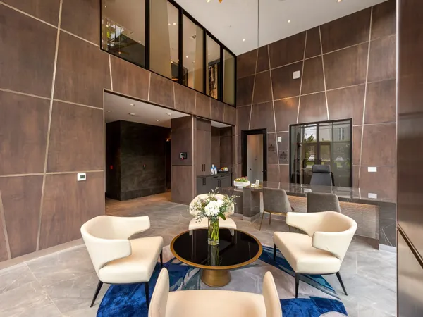a dining room with furniture and a potted plant