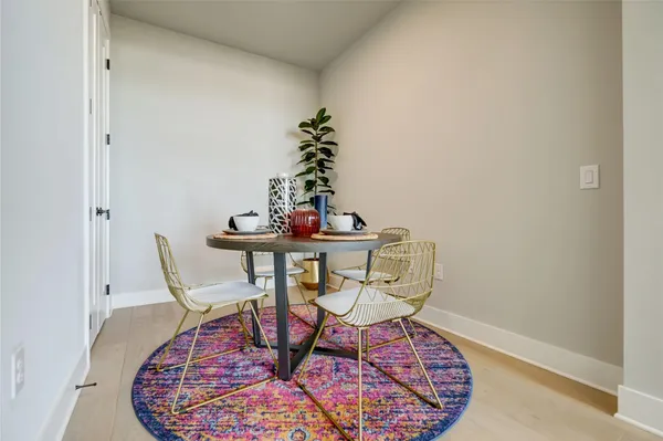 a dining room with furniture and wooden floor