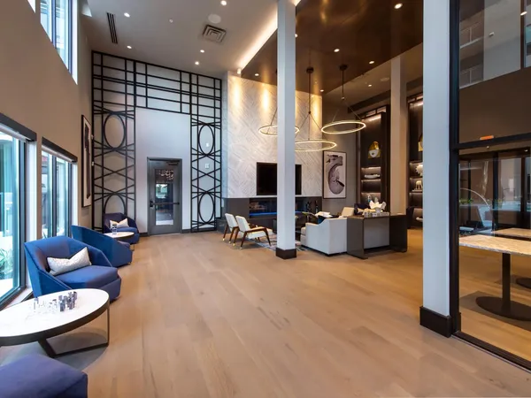 a living room with fireplace furniture and a large window