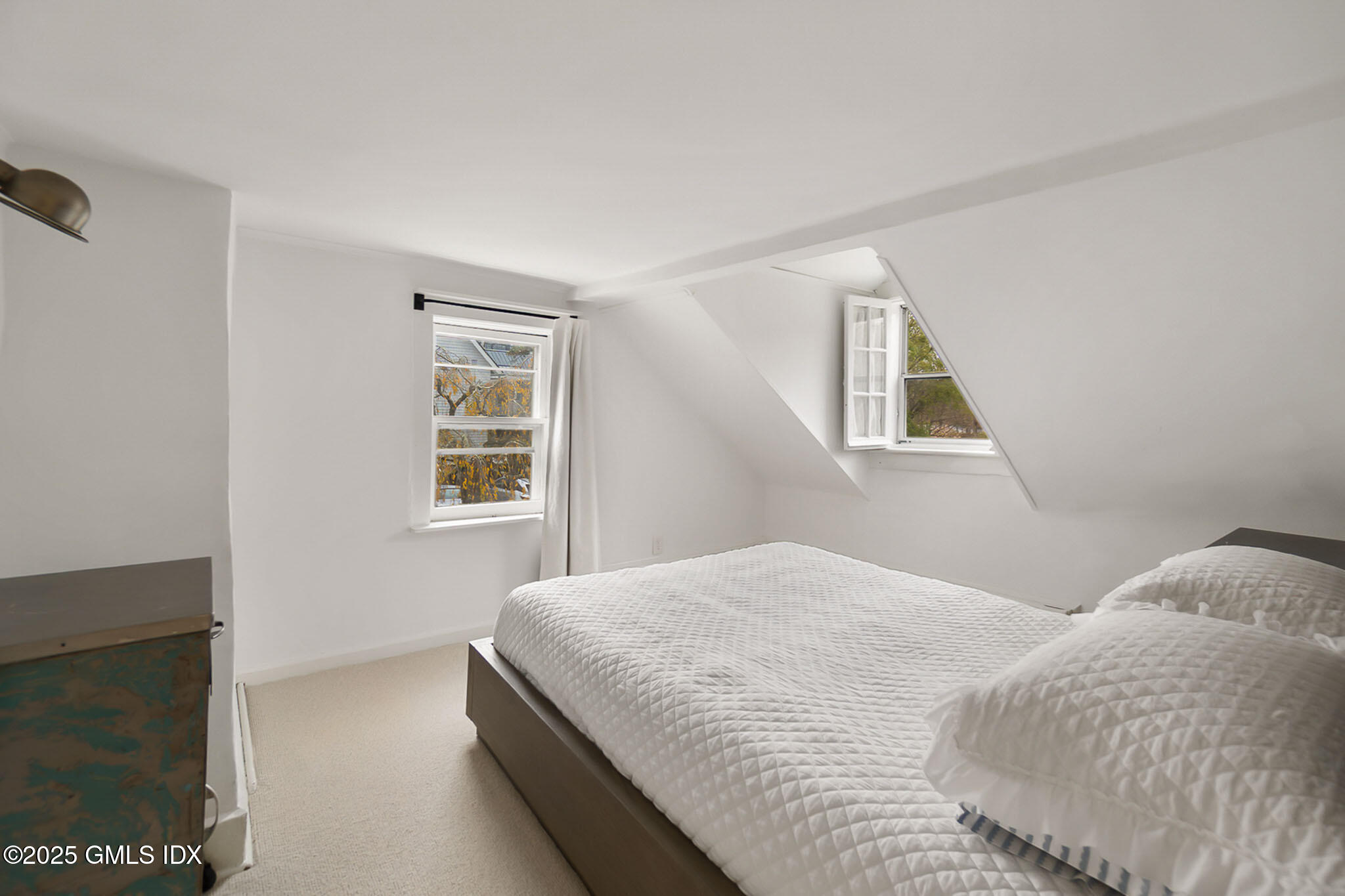 45 Burying Hill Road, Unit COTTAGE Greenwich, CT 06831 - Photo 12 of 19 a bedroom with a bed and a window