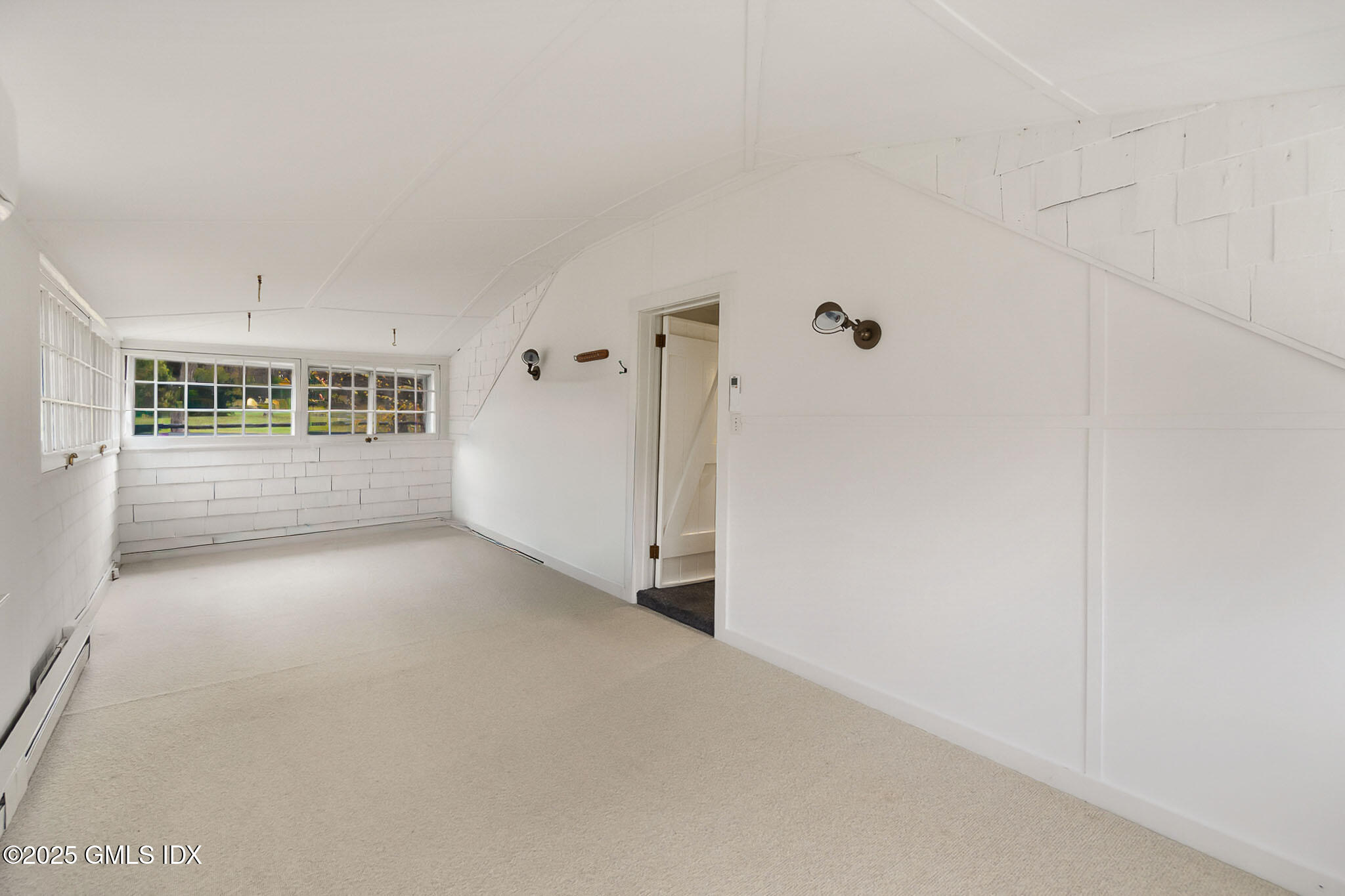 45 Burying Hill Road, Unit COTTAGE Greenwich, CT 06831 - Photo 15 of 19 a view of a big room with wooden floor and windows