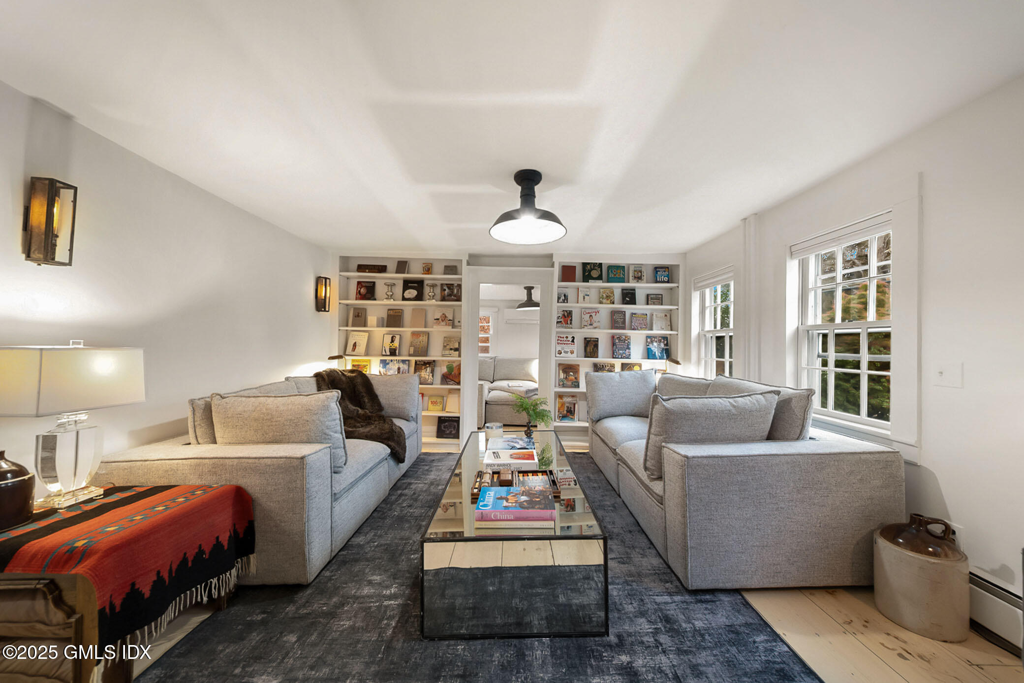 45 Burying Hill Road, Unit COTTAGE Greenwich, CT 06831 - Photo 3 of 19 a living room with furniture and a chandelier