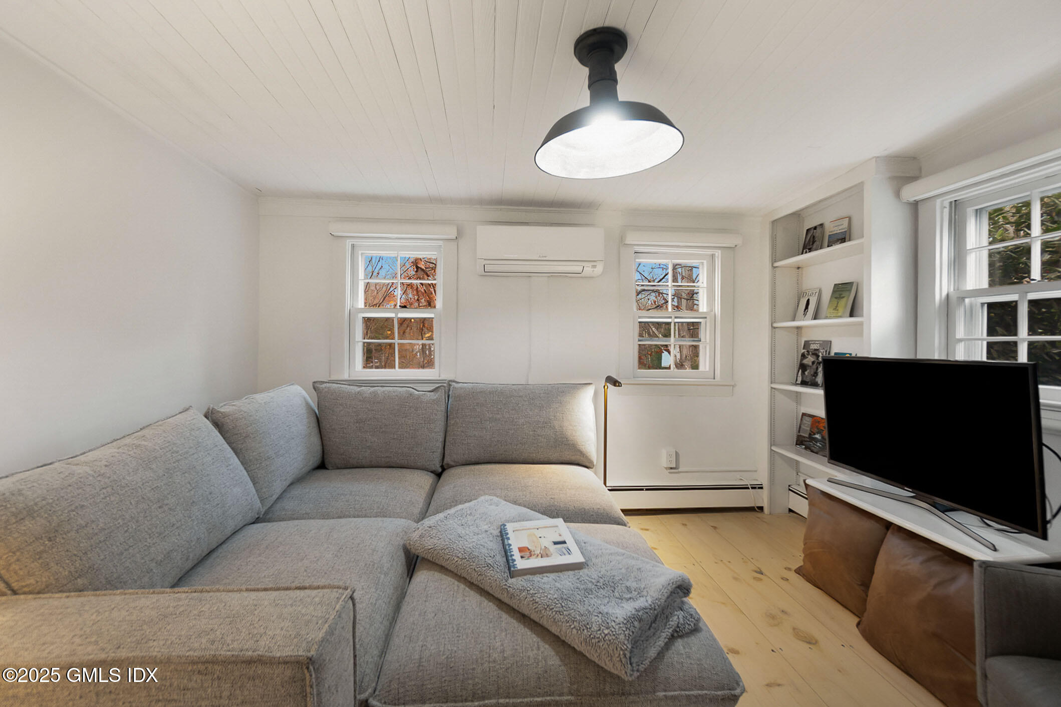 45 Burying Hill Road, Unit COTTAGE Greenwich, CT 06831 - Photo 5 of 19 a living room with furniture and a flat screen tv