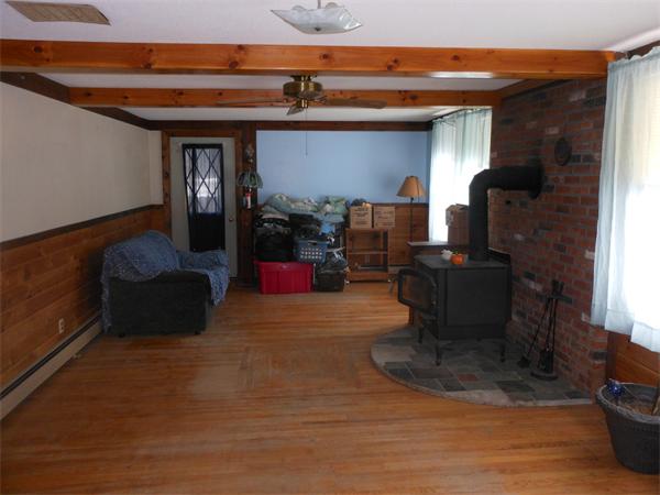 122 Huntington Road Russell, MA 01071 - Photo 6 of 16 a living room with furniture a flat screen tv and a fireplace