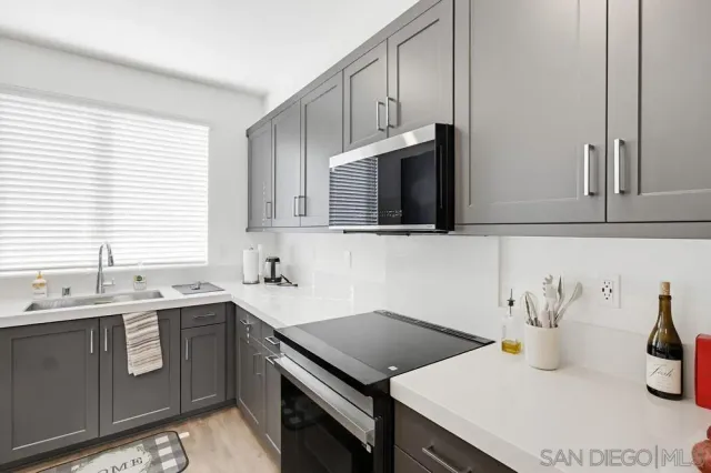 a kitchen with a sink stove and microwave