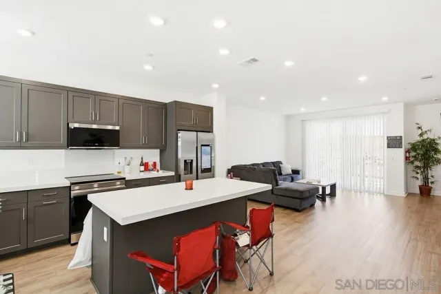 a kitchen with a sink cabinets and wooden floor